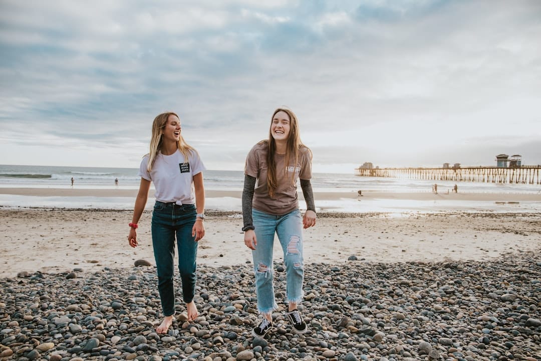 Photo by Vince Fleming two women walking on pebbles